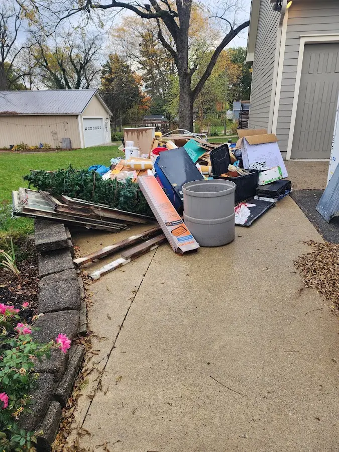 Dumpster being loaded with debris for Estate Cleanout Dumpster Rental in Gary